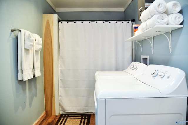 laundry room with independent washer and dryer, dark hardwood / wood-style floors, and ornamental molding