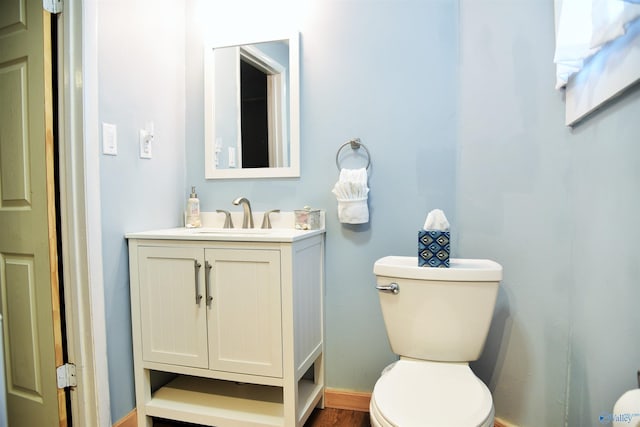 bathroom featuring hardwood / wood-style floors, vanity, and toilet