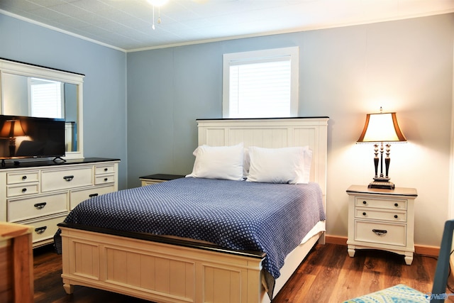 bedroom featuring dark hardwood / wood-style flooring and crown molding