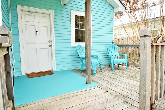 view of exterior entry featuring a wooden deck