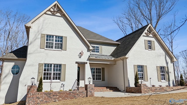 58 Watson Grande Way, Owens Cross Roads, AL 35763 - view of front of home with brick siding, a standing seam roof, roof with shingles, and metal roof