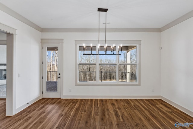 unfurnished dining area with ornamental molding, a healthy amount of sunlight, and dark hardwood / wood-style flooring