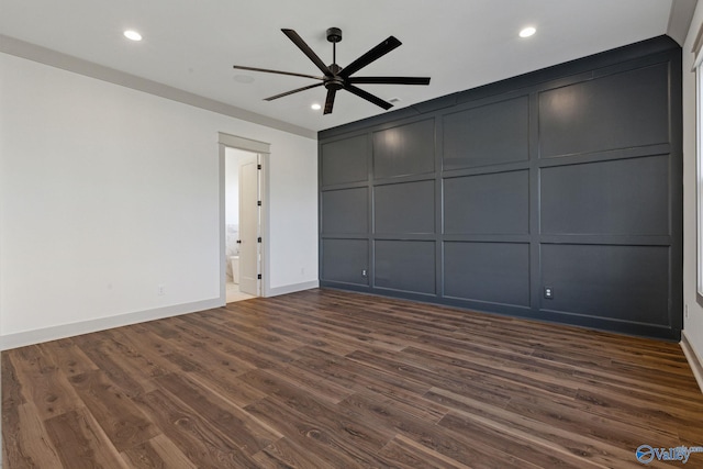 interior space with ceiling fan, connected bathroom, and dark hardwood / wood-style floors