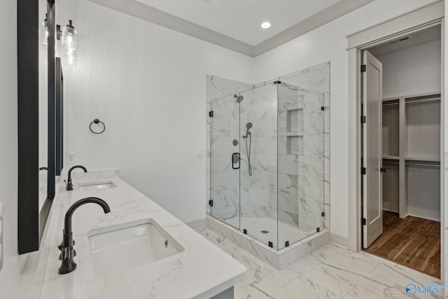 bathroom with vanity and a shower with door