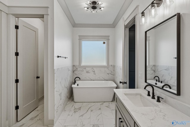 bathroom featuring vanity, a tub to relax in, ornamental molding, and tile walls