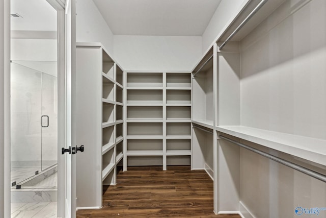 walk in closet featuring dark hardwood / wood-style flooring