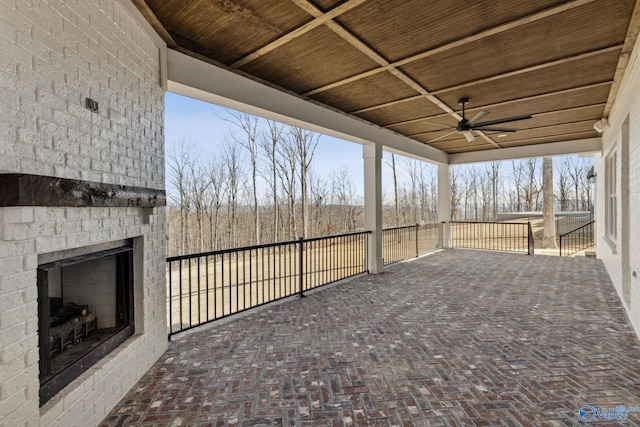 view of patio featuring ceiling fan and a fireplace