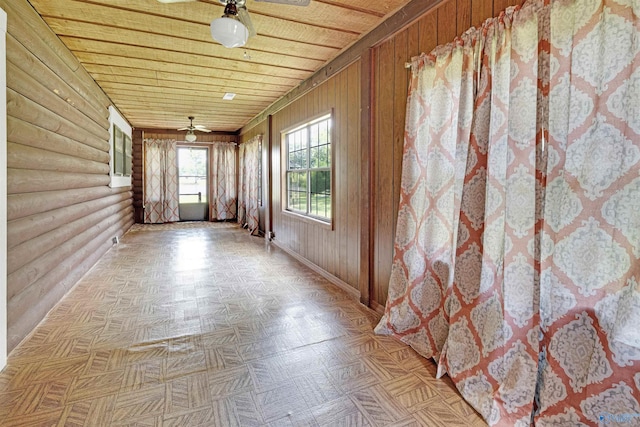 unfurnished sunroom with wood ceiling and ceiling fan