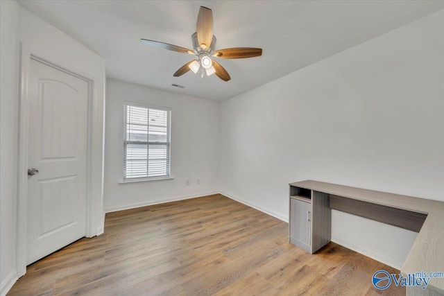 interior space with visible vents, baseboards, ceiling fan, and light wood finished floors