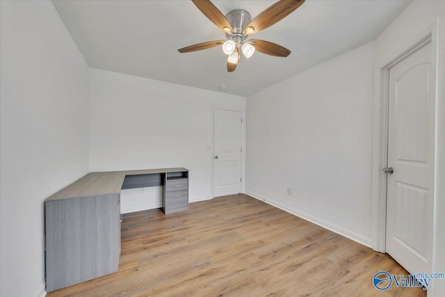 interior space featuring baseboards, light wood-type flooring, and ceiling fan