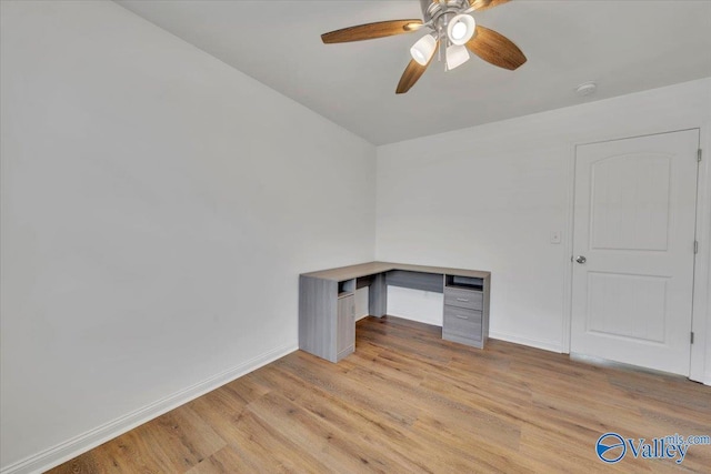 interior space featuring ceiling fan, baseboards, and light wood-style flooring