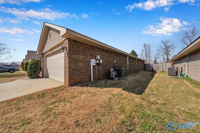 view of side of property featuring a garage, brick siding, central AC unit, and driveway