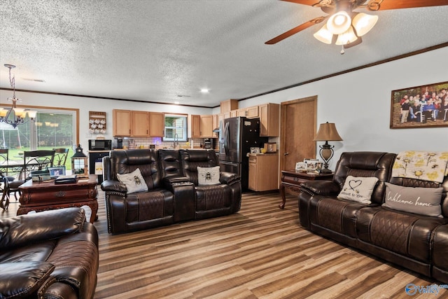 216 Mcdonald Ln, Guntersville, AL 35976 - living room with light wood-type flooring, a textured ceiling, a chandelier, ceiling fan, and ornamental molding