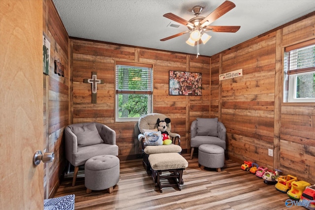 216 Mcdonald Ln, Guntersville, AL 35976 - living area with plenty of natural light, wood finished floors, ceiling fan, and wooden walls