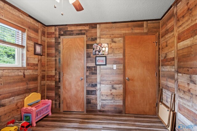 216 Mcdonald Ln, Guntersville, AL 35976 - entryway with wooden walls, a ceiling fan, wood finished floors, and a textured ceiling