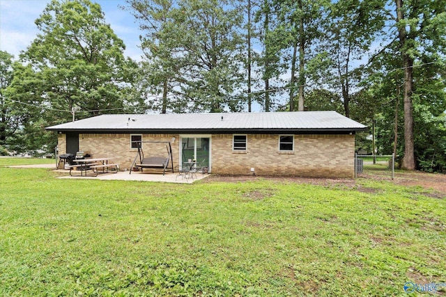 216 Mcdonald Ln, Guntersville, AL 35976 - back of property featuring a patio area, brick siding, a metal roof, and view of wooded area