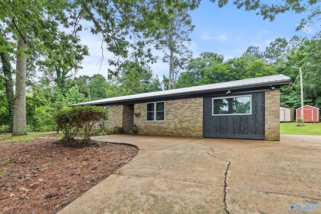 216 Mcdonald Ln, Guntersville, AL 35976 - view of front of home featuring a storage unit, a metal roof, and a patio area