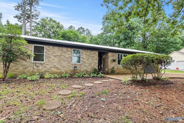 216 Mcdonald Ln, Guntersville, AL 35976 - single story home with brick siding, a metal roof, and a patio area