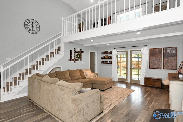 living room featuring stairs, recessed lighting, a high ceiling, and hardwood / wood-style flooring