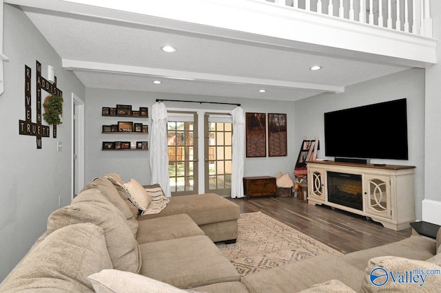 living room with wood finished floors, recessed lighting, and beam ceiling