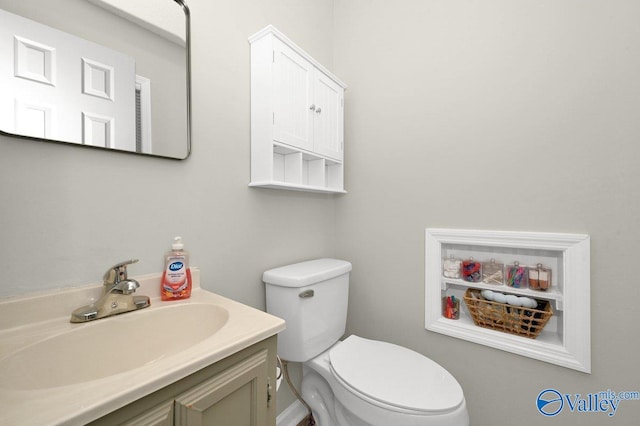 bathroom featuring toilet and vanity