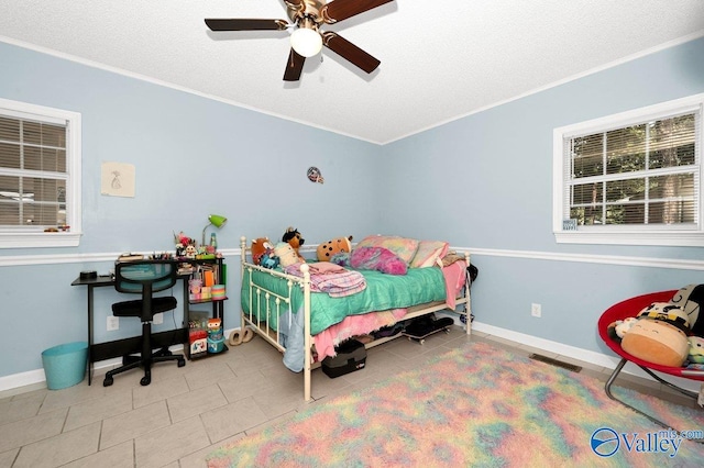 bedroom with tile patterned flooring, crown molding, baseboards, and visible vents