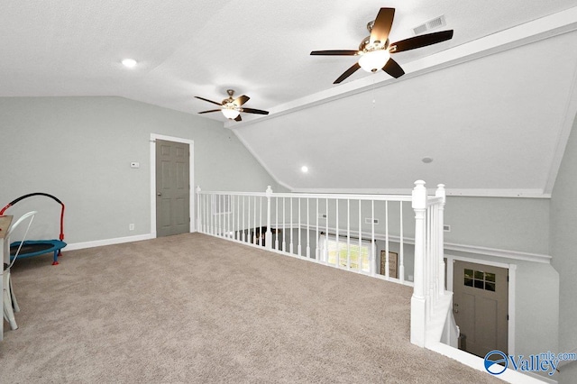 game room featuring carpet flooring, visible vents, vaulted ceiling, and ceiling fan
