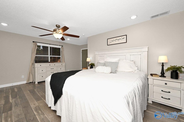 bedroom featuring dark wood-style flooring, a textured ceiling, visible vents, baseboards, and recessed lighting