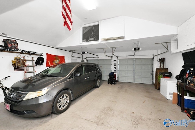 garage with a garage door opener and fridge