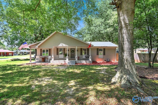 single story home with a front lawn, covered porch, and central AC