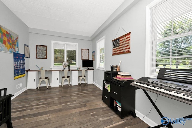 interior space with baseboards, dark wood-style flooring, and visible vents
