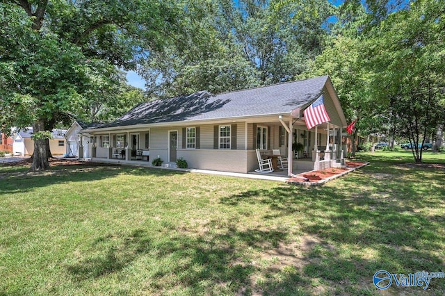 back of house with a lawn, a patio, and brick siding