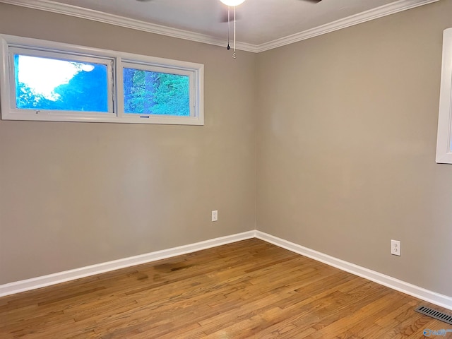 empty room with ornamental molding, ceiling fan, and light hardwood / wood-style flooring