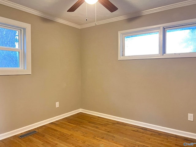 unfurnished room featuring ornamental molding, light wood-type flooring, and ceiling fan