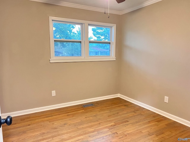 spare room with crown molding, light hardwood / wood-style floors, and ceiling fan