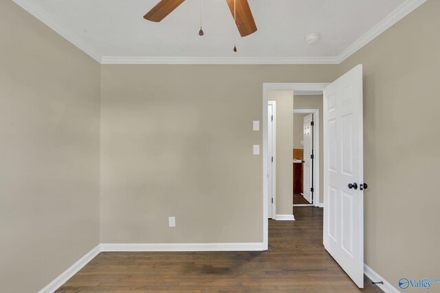 spare room featuring baseboards, ornamental molding, ceiling fan, and wood finished floors
