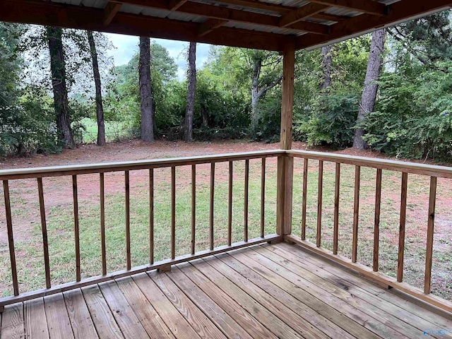 wooden deck with a lawn