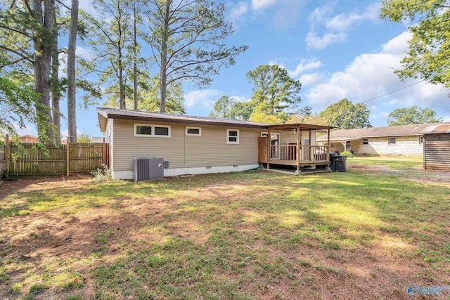 rear view of house with fence, a deck, crawl space, a lawn, and central air condition unit