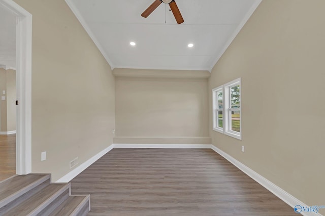 spare room with lofted ceiling, ornamental molding, ceiling fan, and light hardwood / wood-style flooring