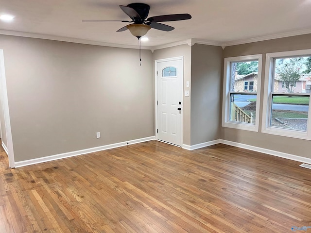 entrance foyer with light wood-type flooring, ceiling fan, and crown molding