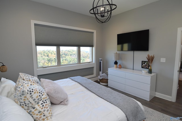 bedroom with a notable chandelier and hardwood / wood-style floors