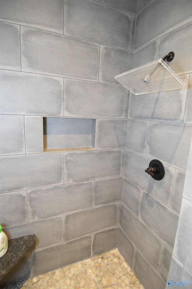 bathroom with a tile shower