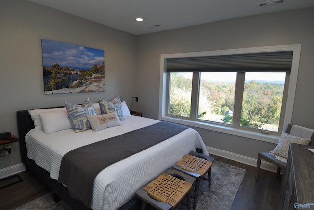 bedroom with dark hardwood / wood-style flooring