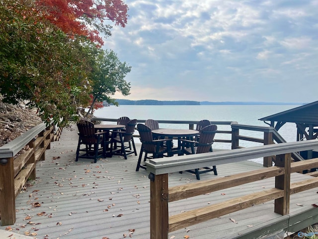 wooden deck featuring a water and mountain view