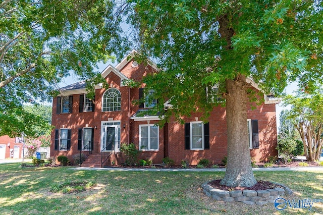 colonial-style house with a front yard