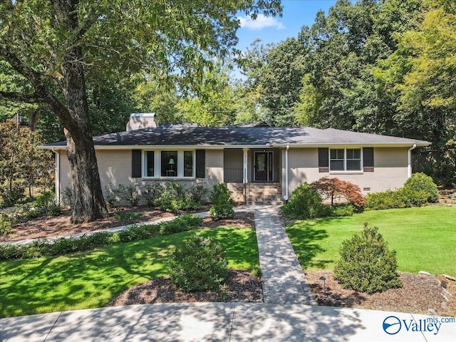 single story home with brick siding and a front lawn