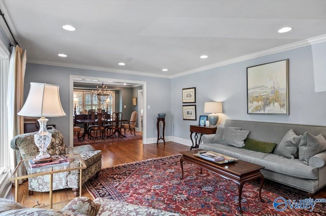 dining area with ceiling fan with notable chandelier, a fireplace, wood finished floors, and ornamental molding