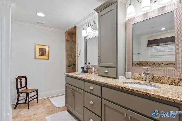 bathroom with a tile shower, crown molding, and vanity