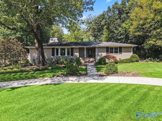 ranch-style house featuring a garage, driveway, stucco siding, and a front lawn
