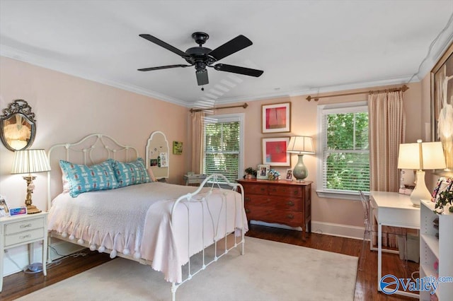 bedroom featuring crown molding, hardwood / wood-style floors, and ceiling fan